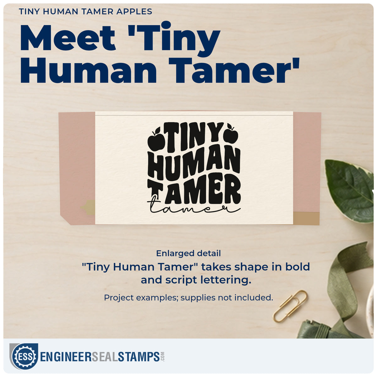 Enlarged detail of the Tiny Human Tamer Apples Script Lettering Stamp – Wood Handle imprint. “Tiny Human Tamer” appears in bold lettering with apples and an additional script “Tamer.”