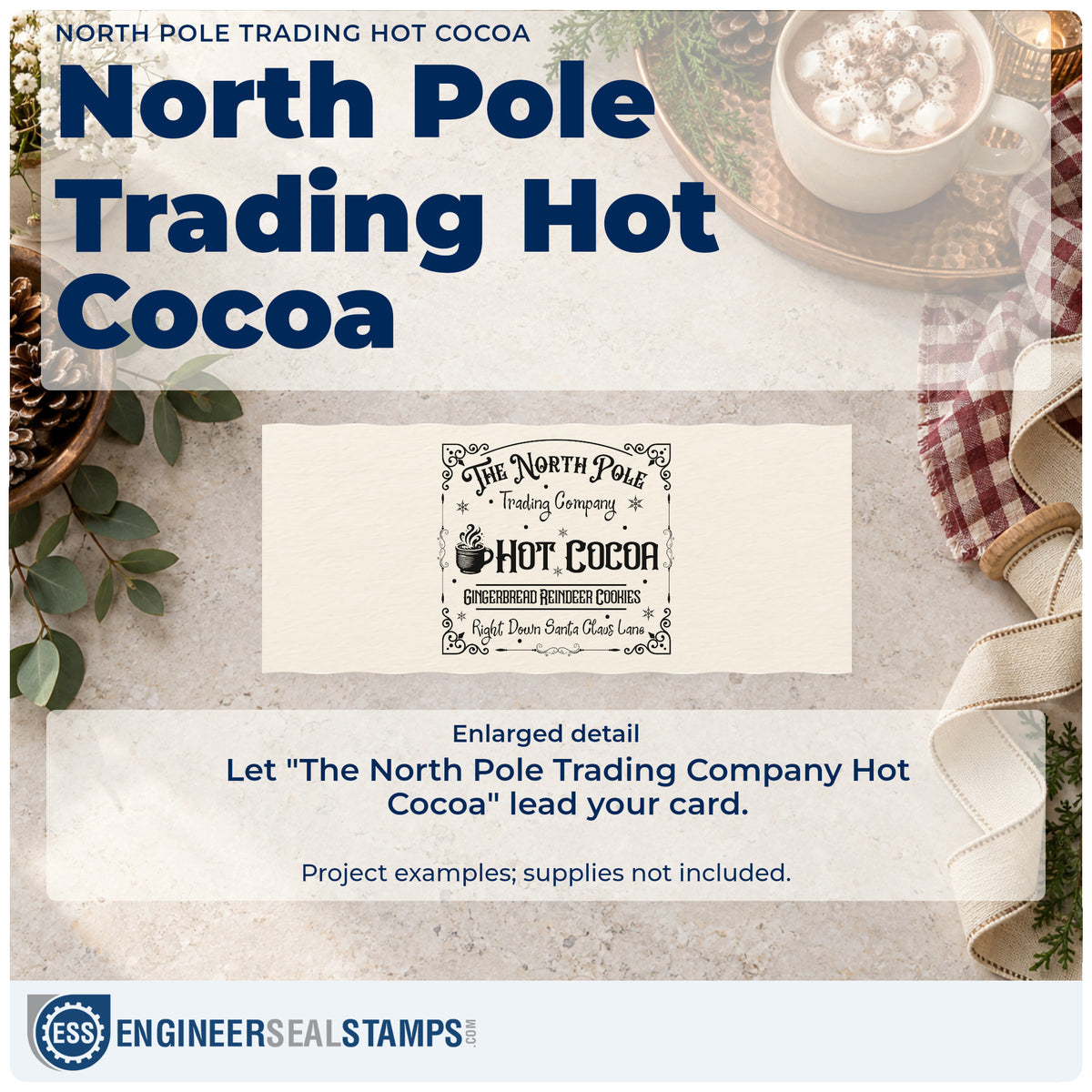 Enlarged detail of the North Pole Trading Hot Cocoa Stamp – Duo Hand imprint. An ornate rectangular sign reads "The North Pole Trading Company Hot Cocoa" with a steaming mug and gingerbread-reindeer-cookie text.