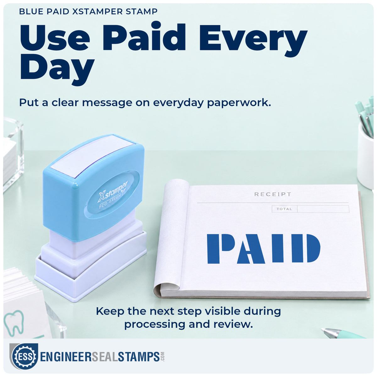 "Paid" stamp being pressed onto a document during everyday filing