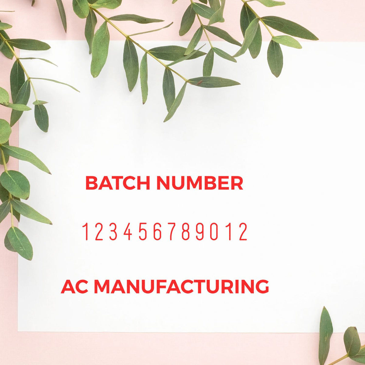 Red batch number stamp and seal reading 123456789012, AC Manufacturing, on white card with green leaves and pink border.