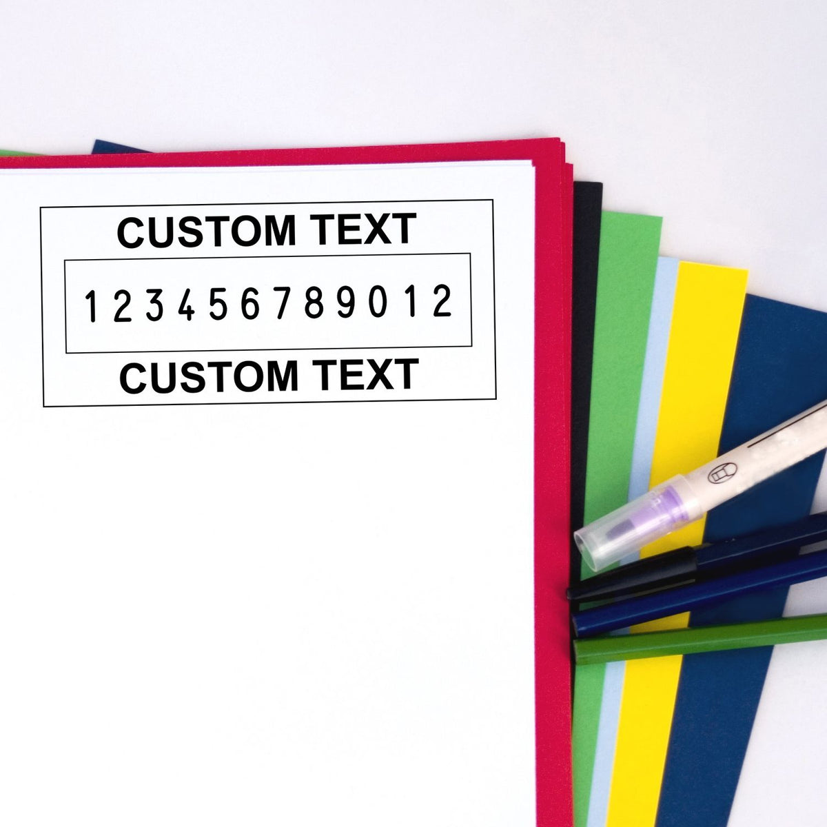 Custom text stamp and seal set with red, green, yellow, and blue covers, plus black pen on a white background.