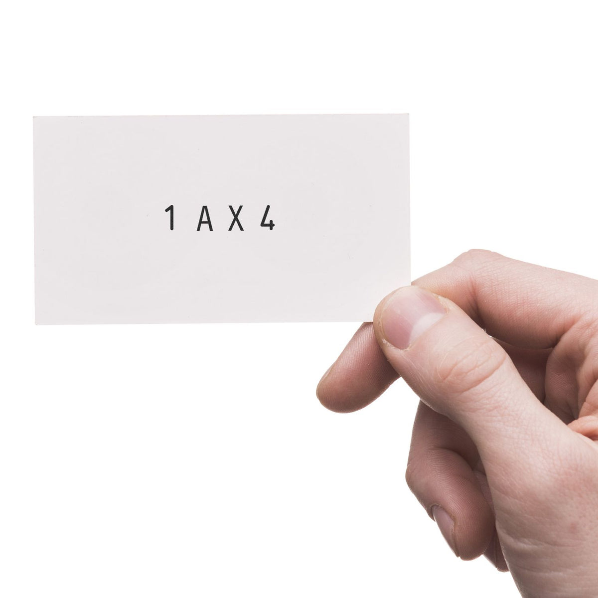 Hand holding a white stamp and seal card marked 1 AX 4 in black text on a clean white background.