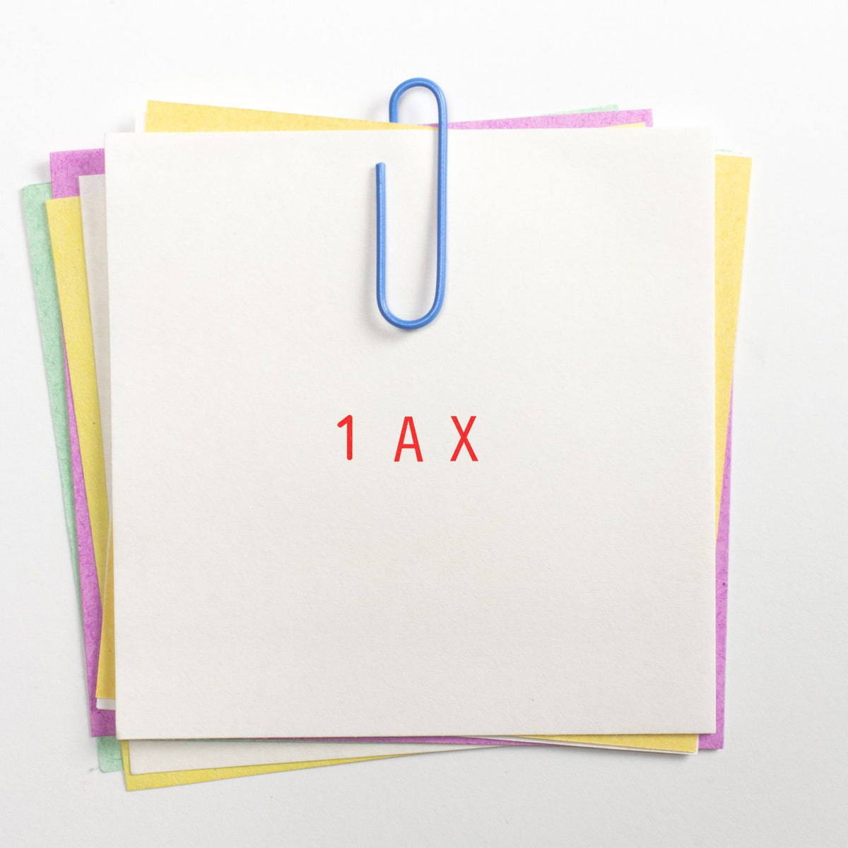 Stamp and seal product sheets clipped with a blue paper clip, pastel edges, and red 1 AX text.