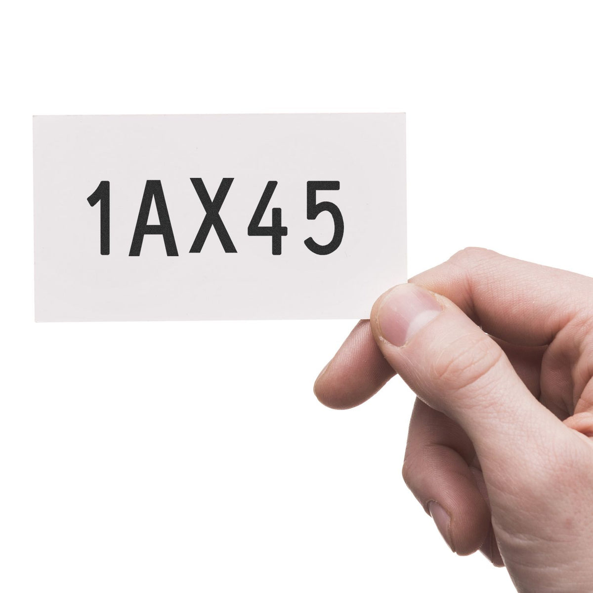 Hand holding a white stamp and seal card with bold black 1AX45 code