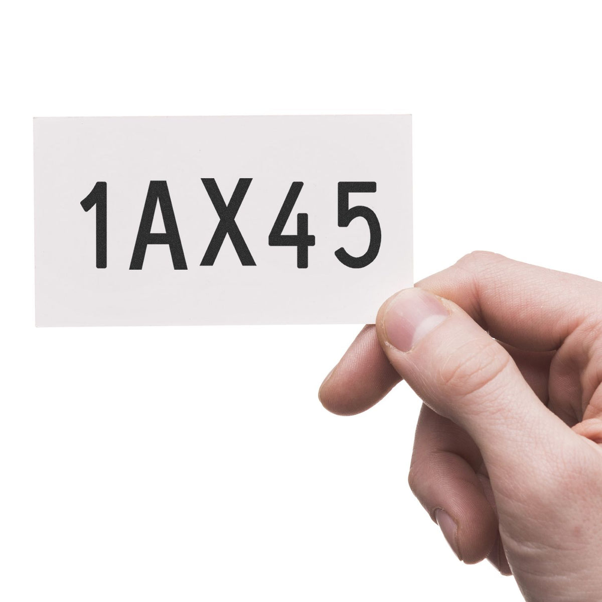 Hand holding white stamp seal card with black 1AX45 text on a clean white background.