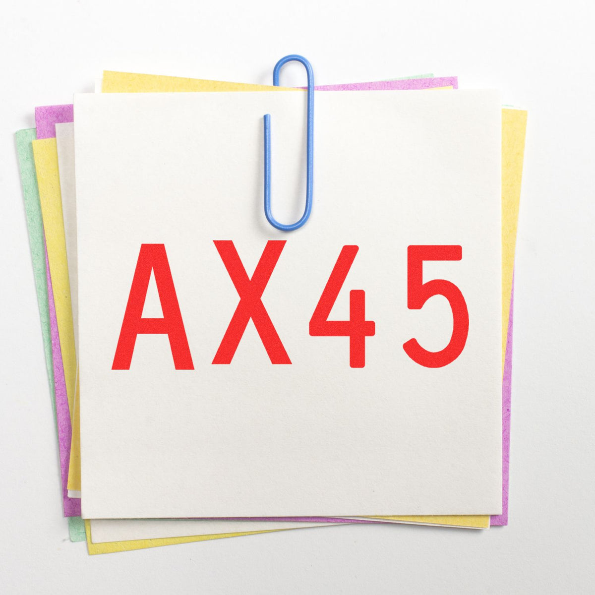 Stamp and seal product cards stacked with pastel edges, clipped by a blue paper clip, labeled AX45 in bold red.