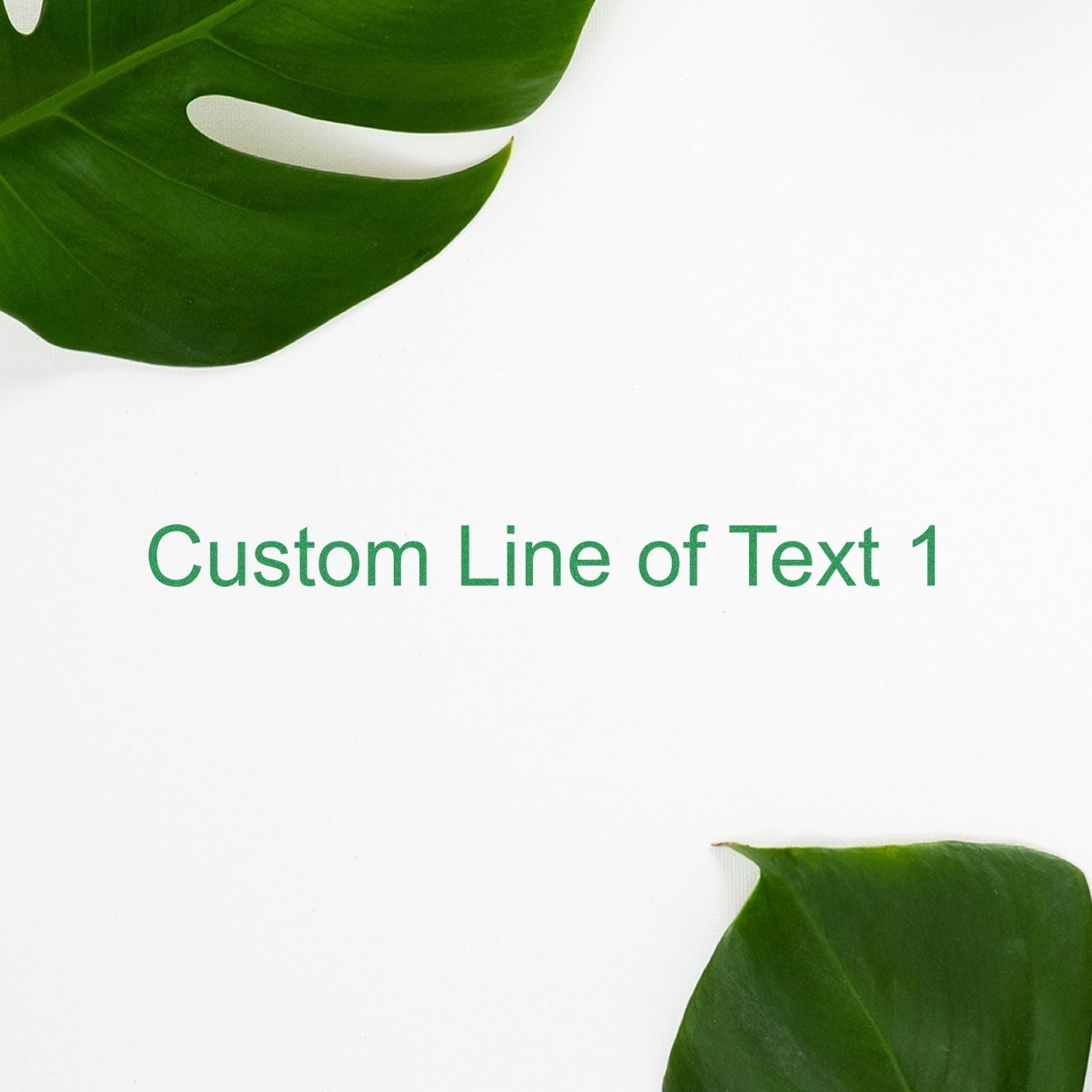 Custom Line of Text 1 stamped in green ink on white paper, surrounded by green leaves, using the 1 Line Custom Rubber Stamp with Wood Handle.