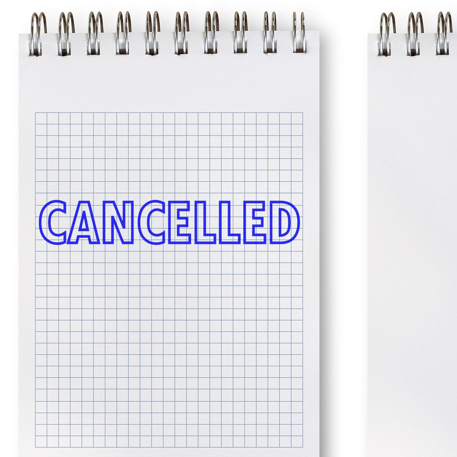 Large Pre-Inked Cancelled Stamp in blue ink on a grid-patterned notepad, with the word CANCELLED clearly visible.