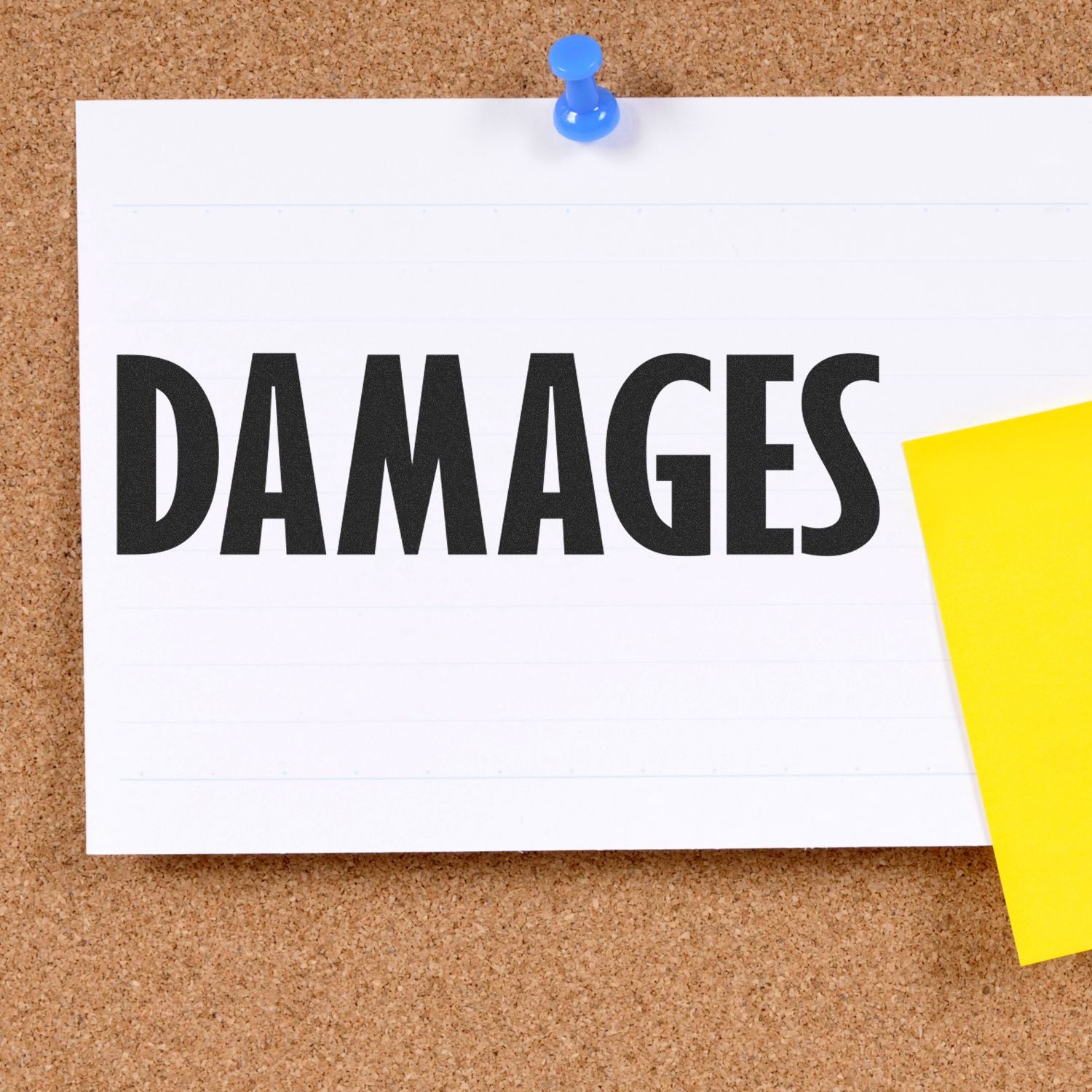 A corkboard with a pinned note displaying the word DAMAGES stamped using the Large Pre-Inked Damages Stamp, next to a yellow sticky note.