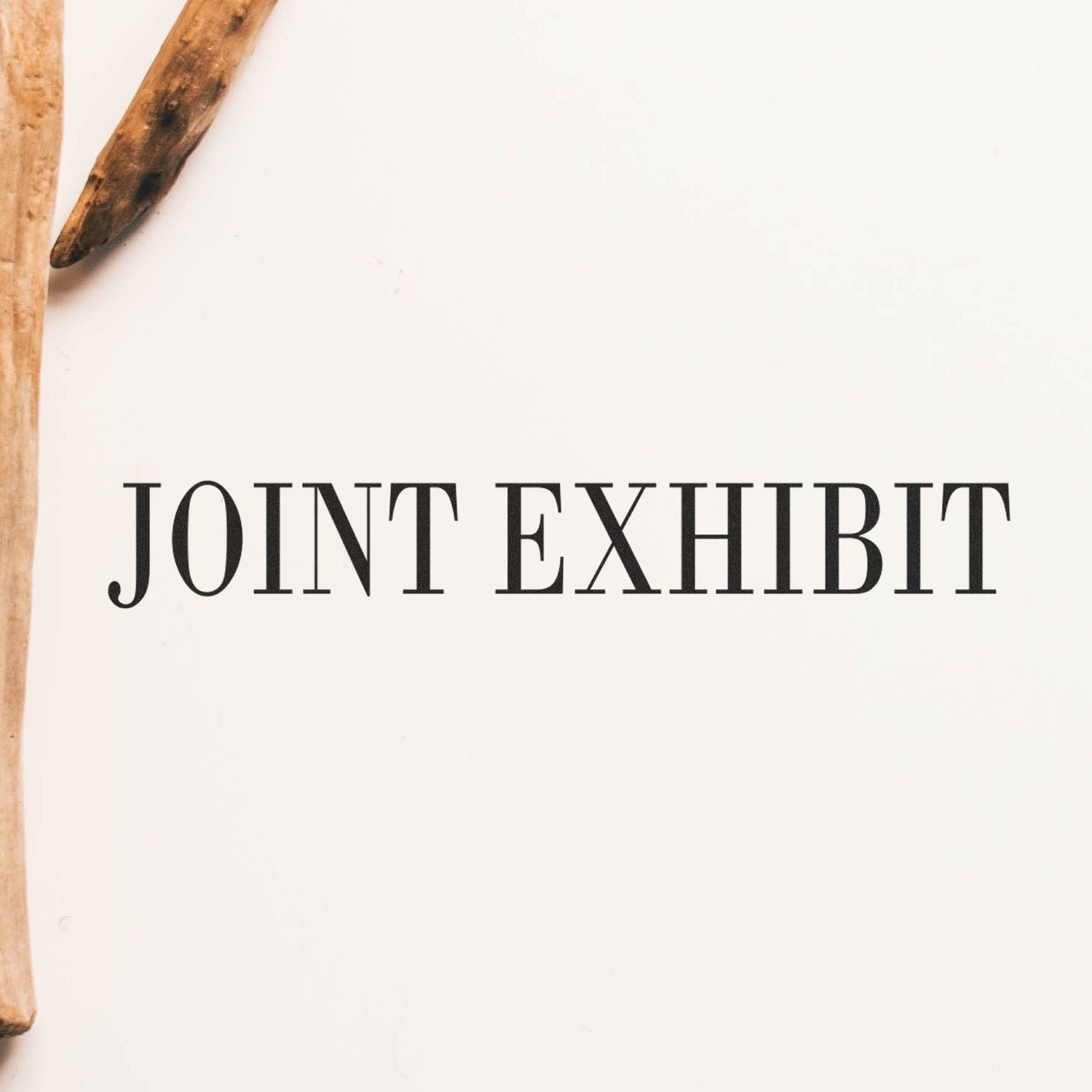 Image of a Large Pre-Inked Joint Exhibit Stamp imprint on a white surface with wooden sticks on the left side.