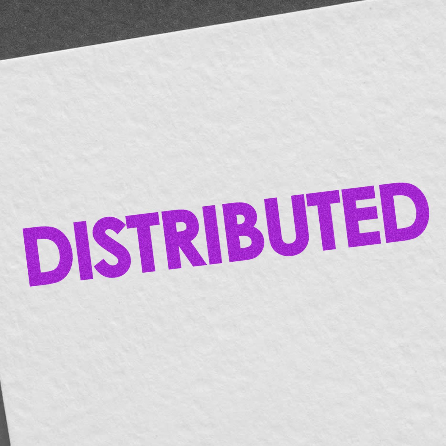 Large Pre-Inked Bold Distributed Stamp in purple ink on white paper, showcasing the word DISTRIBUTED in bold, uppercase letters.