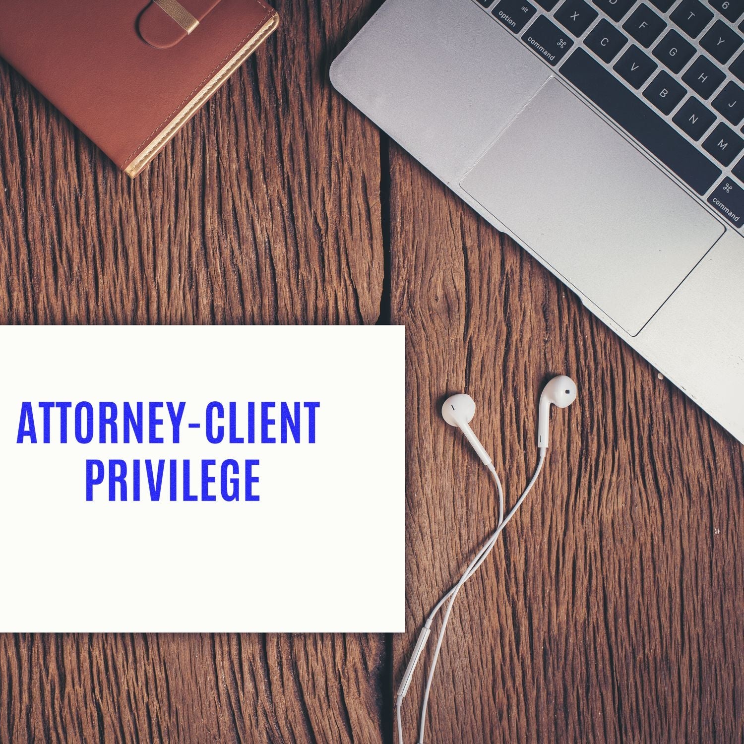 Large Pre-Inked Attorney-Client Privilege Stamp on a wooden desk with a laptop, notebook, and earphones nearby.