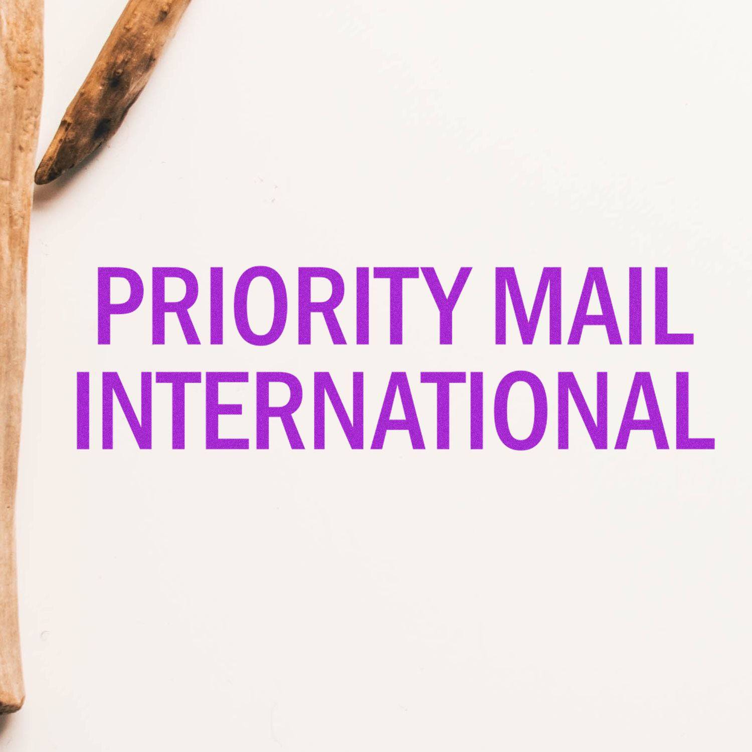 Large Pre-Inked Priority Mail International Stamp with purple text on a white background, bordered by two wooden sticks.