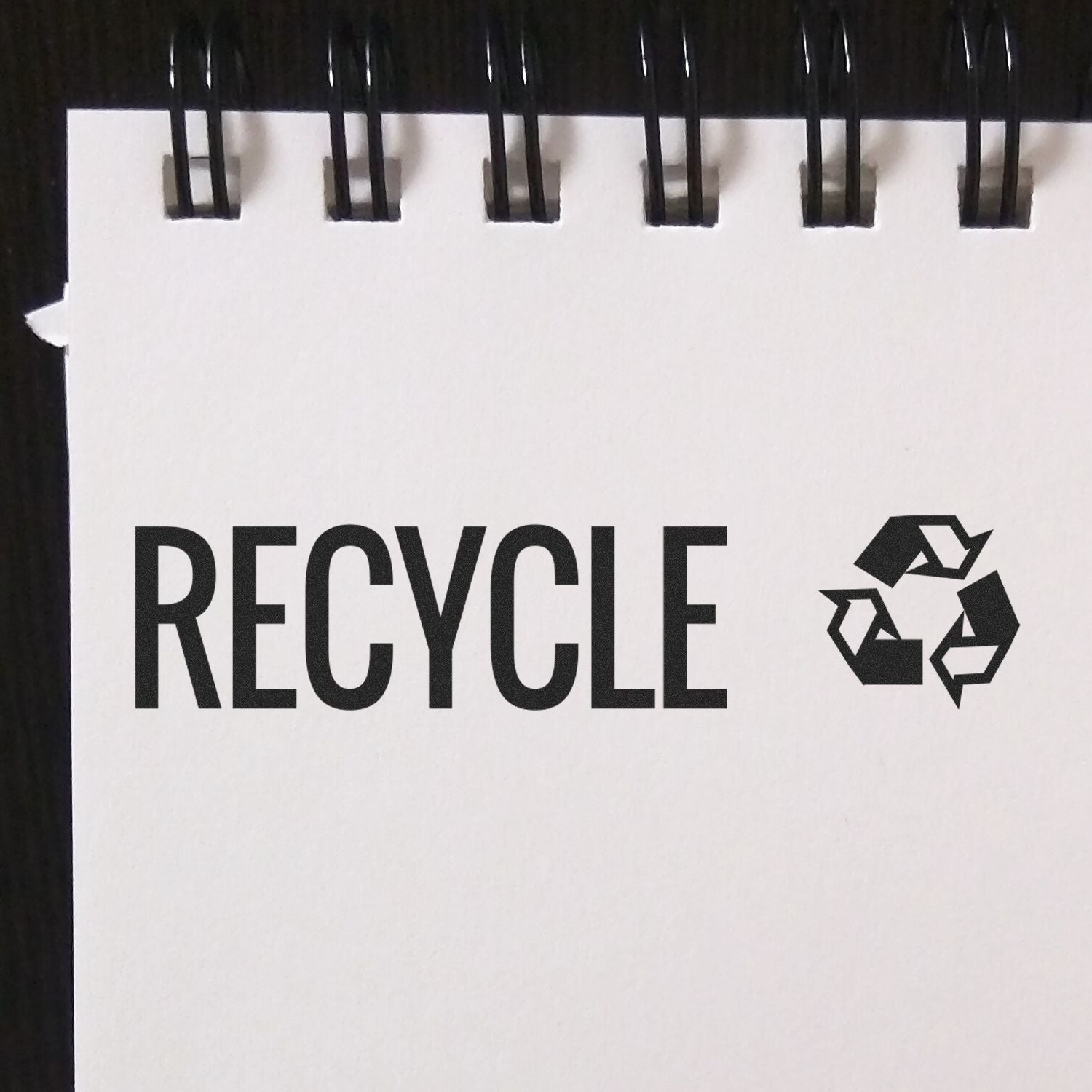 Large Pre-Inked Recycle with Logo Stamp on a white notepad with a black spiral binding, featuring the word RECYCLE and a recycling symbol.