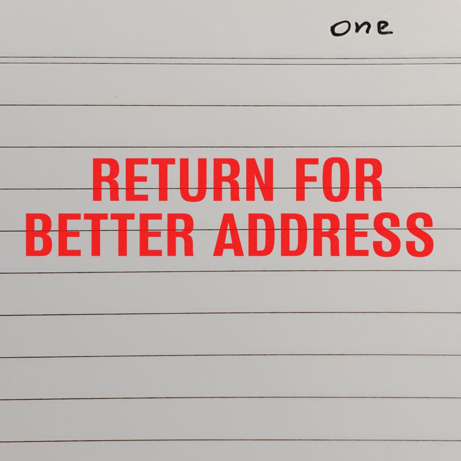 Large Pre-Inked Return for Better Address Stamp in red ink on lined paper, with the word one handwritten at the top right corner.