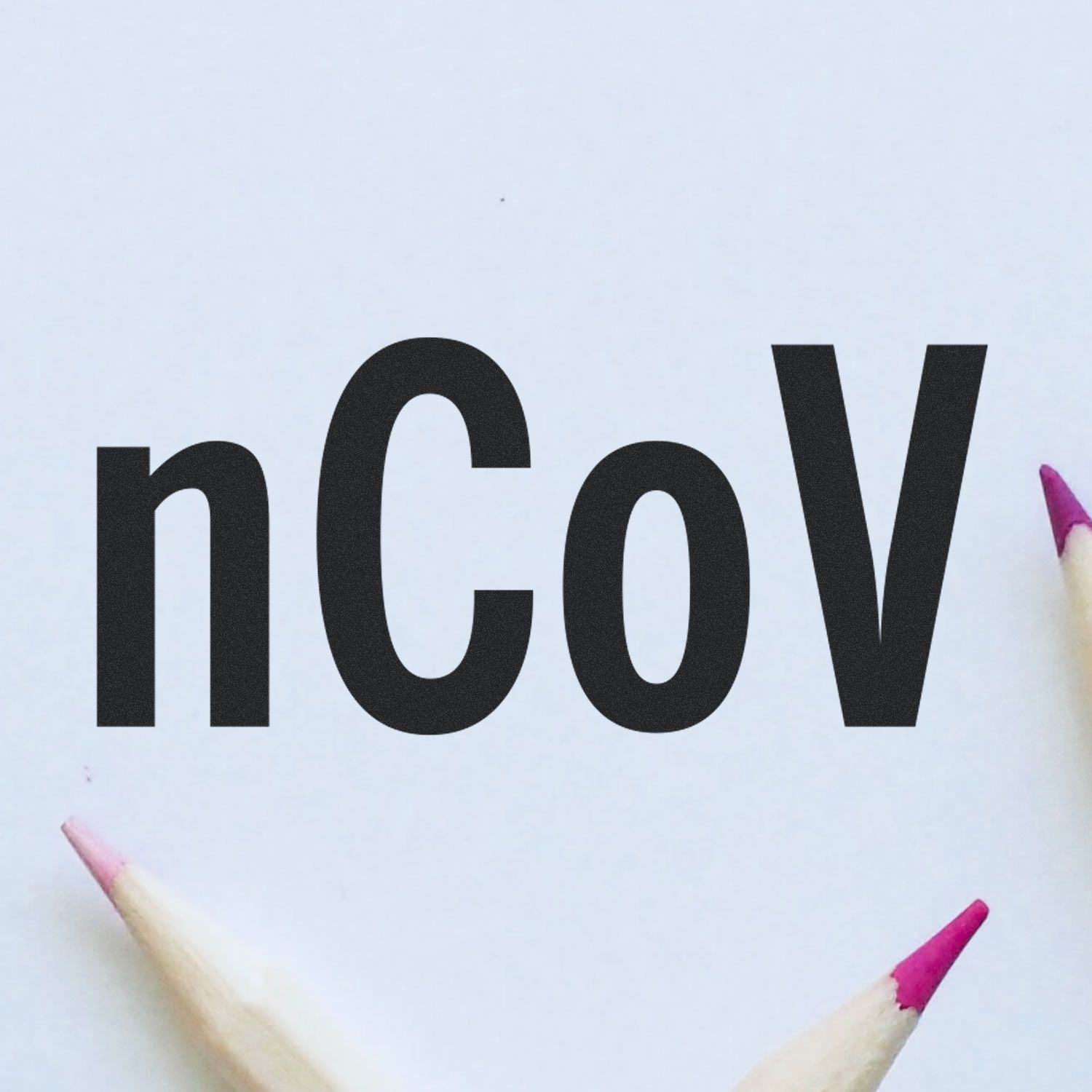 Image of the Large Self Inking nCov Stamp imprinting 'nCoV' on paper, with colored pencils in the corners.