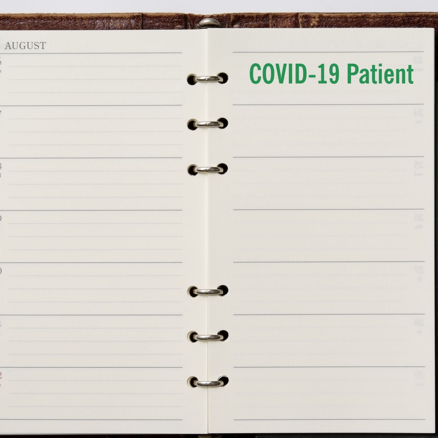 Open planner with COVID-19 Patient stamped in green on the right page using the Large Self Inking Covid-19 Patient Stamp.