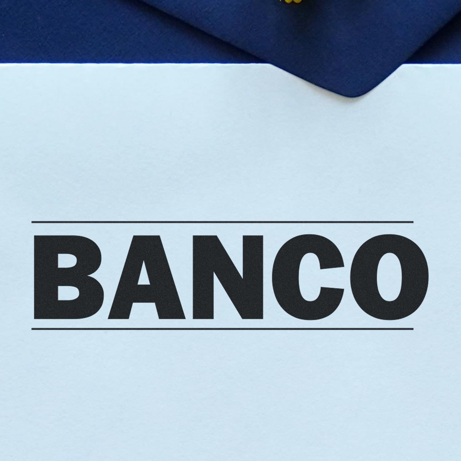 Large Self Inking Bold Banco Stamp imprint on white paper, showcasing the word BANCO in bold black letters with a blue envelope in the background.