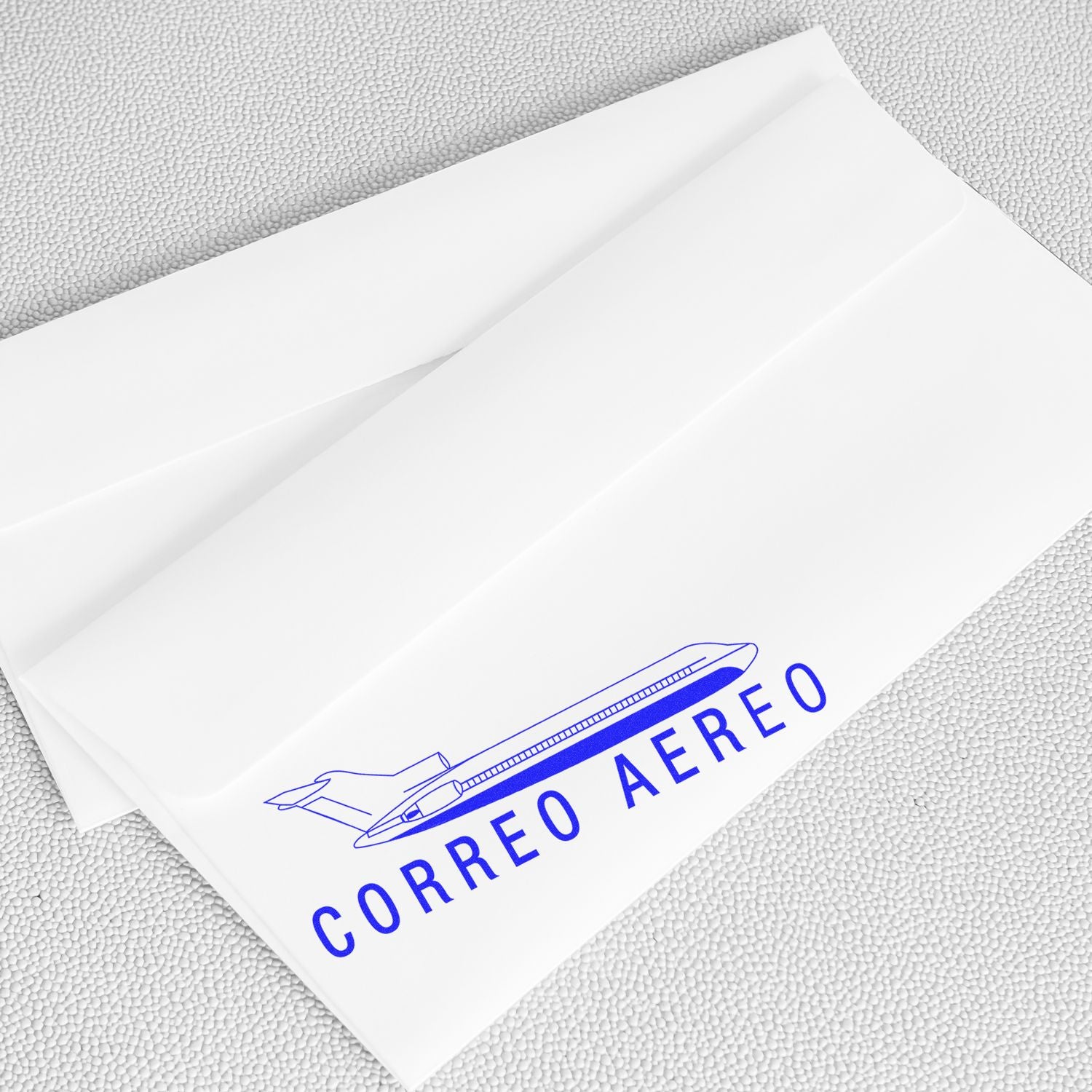 White envelopes stamped with the Large Self Inking Correo Aero Stamp, featuring a blue airplane and text CORREO AEREO on a light background.