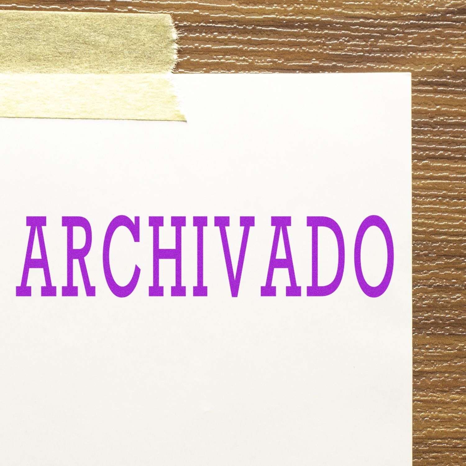 Large Self Inking Archivado Stamp in purple ink on white paper, taped to a wooden surface.