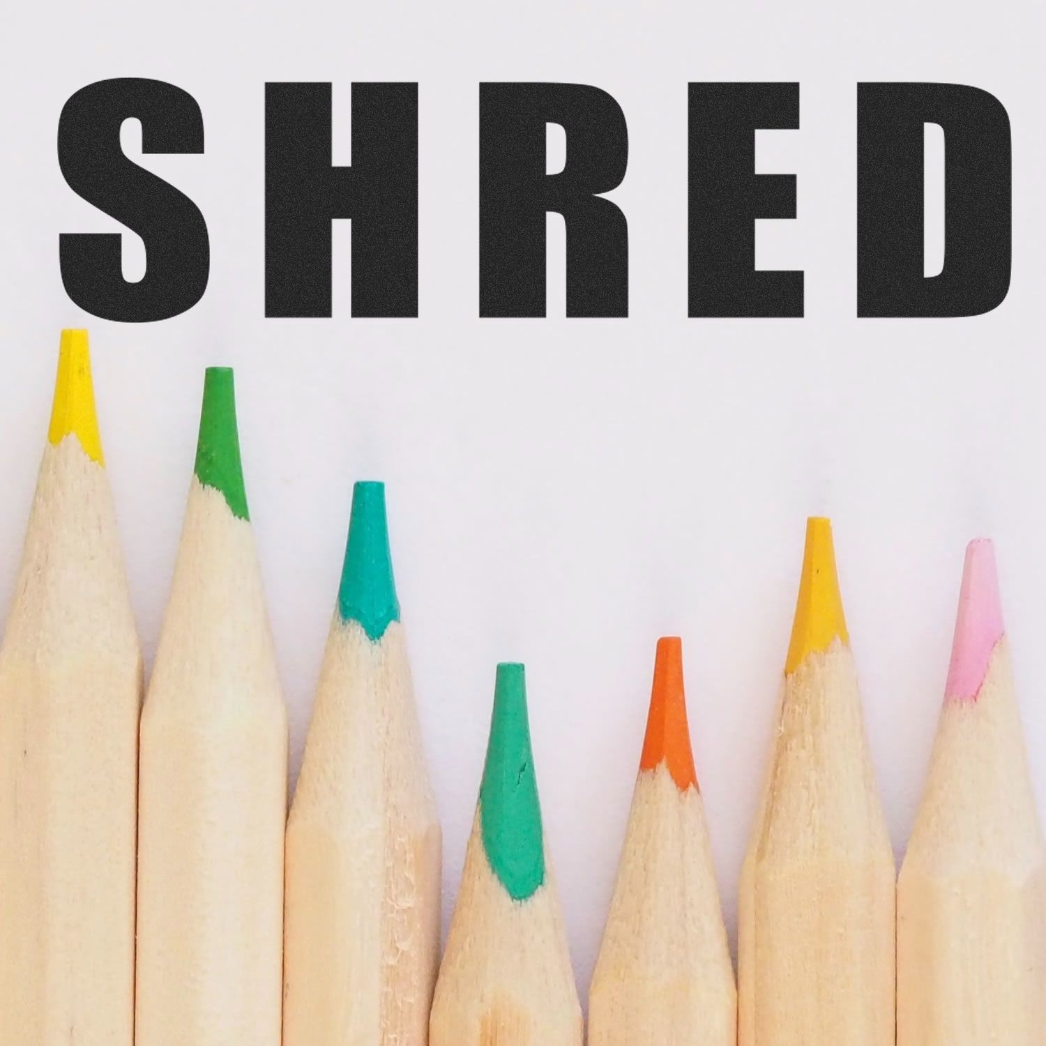 Image of the Large Pre-Inked Bold Shred Stamp with the word SHRED stamped above a row of colored pencils.