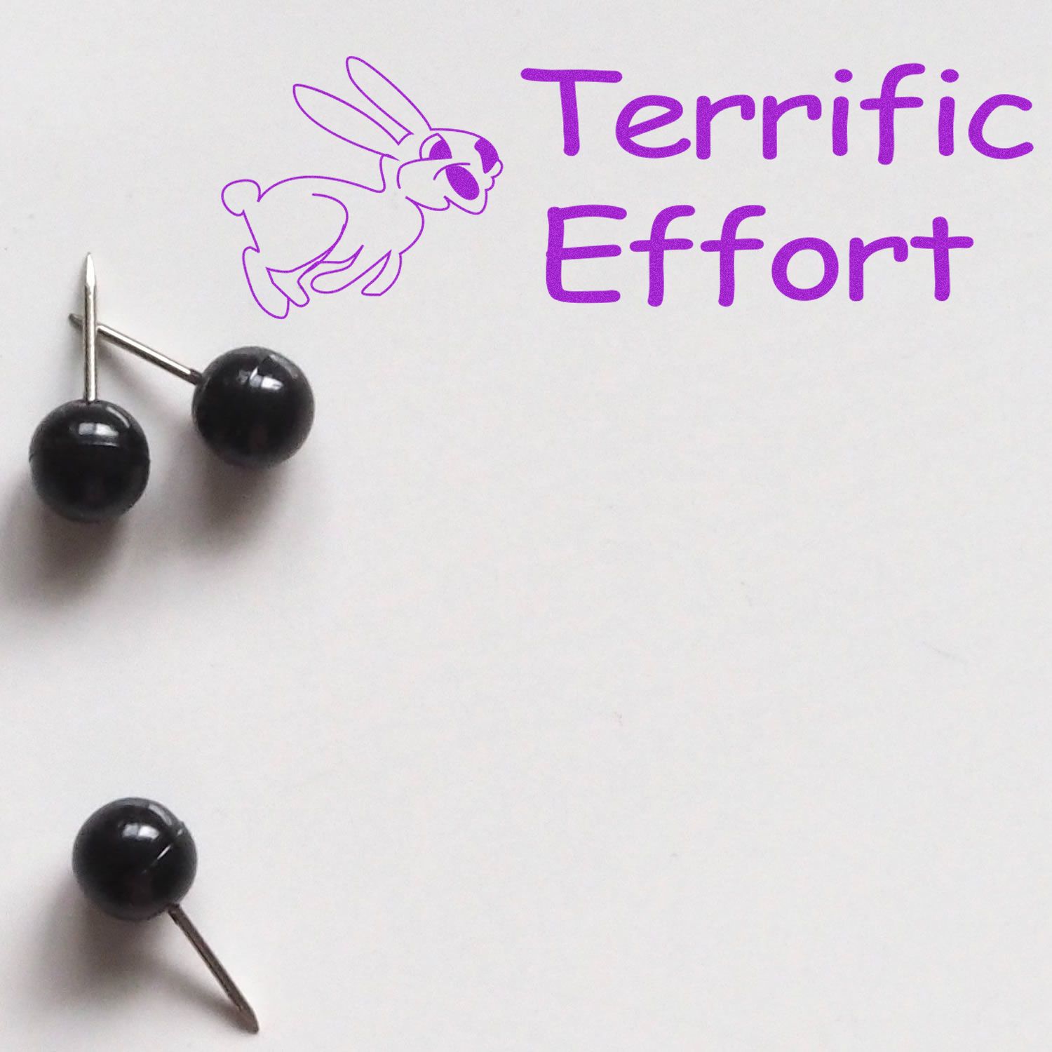 Large Pre-Inked Terrific Effort Stamp with a purple bunny and text Terrific Effort next to two black push pins on a white background.