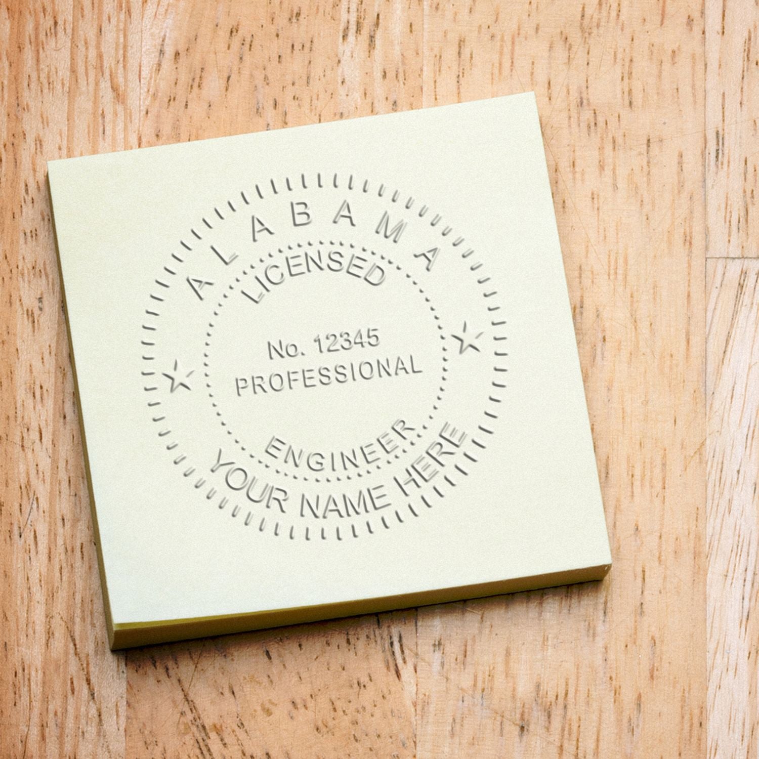 An in use photo of the Gift Alabama Engineer Seal showing a sample imprint on a cardstock