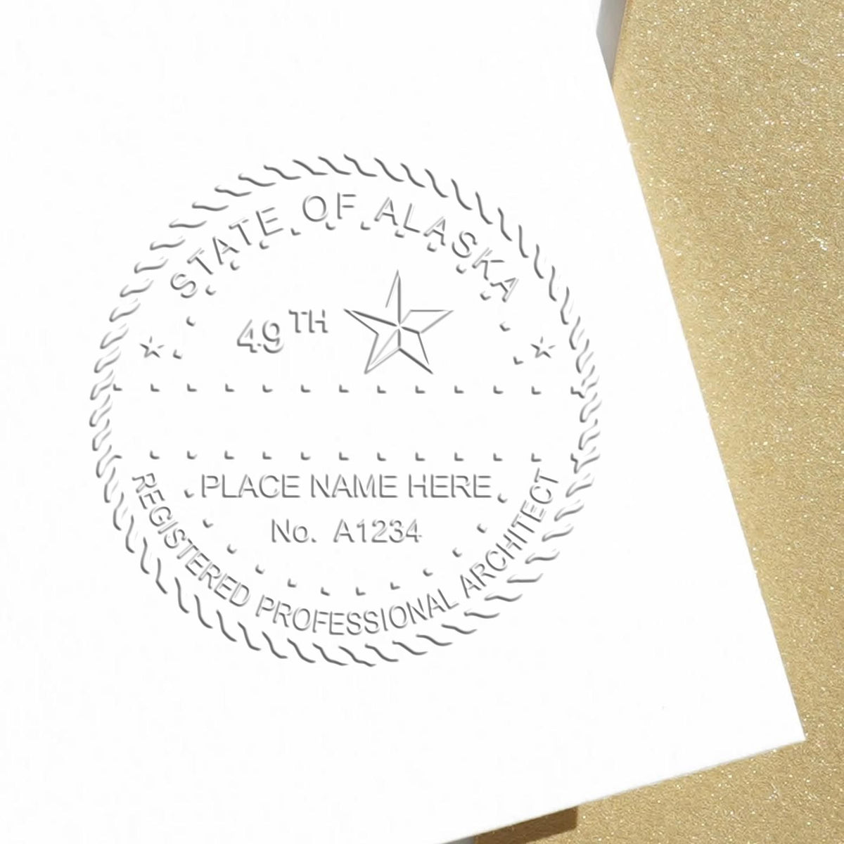 A lifestyle photo showing a stamped image of the Alaska Desk Architect Embossing Seal on a piece of paper