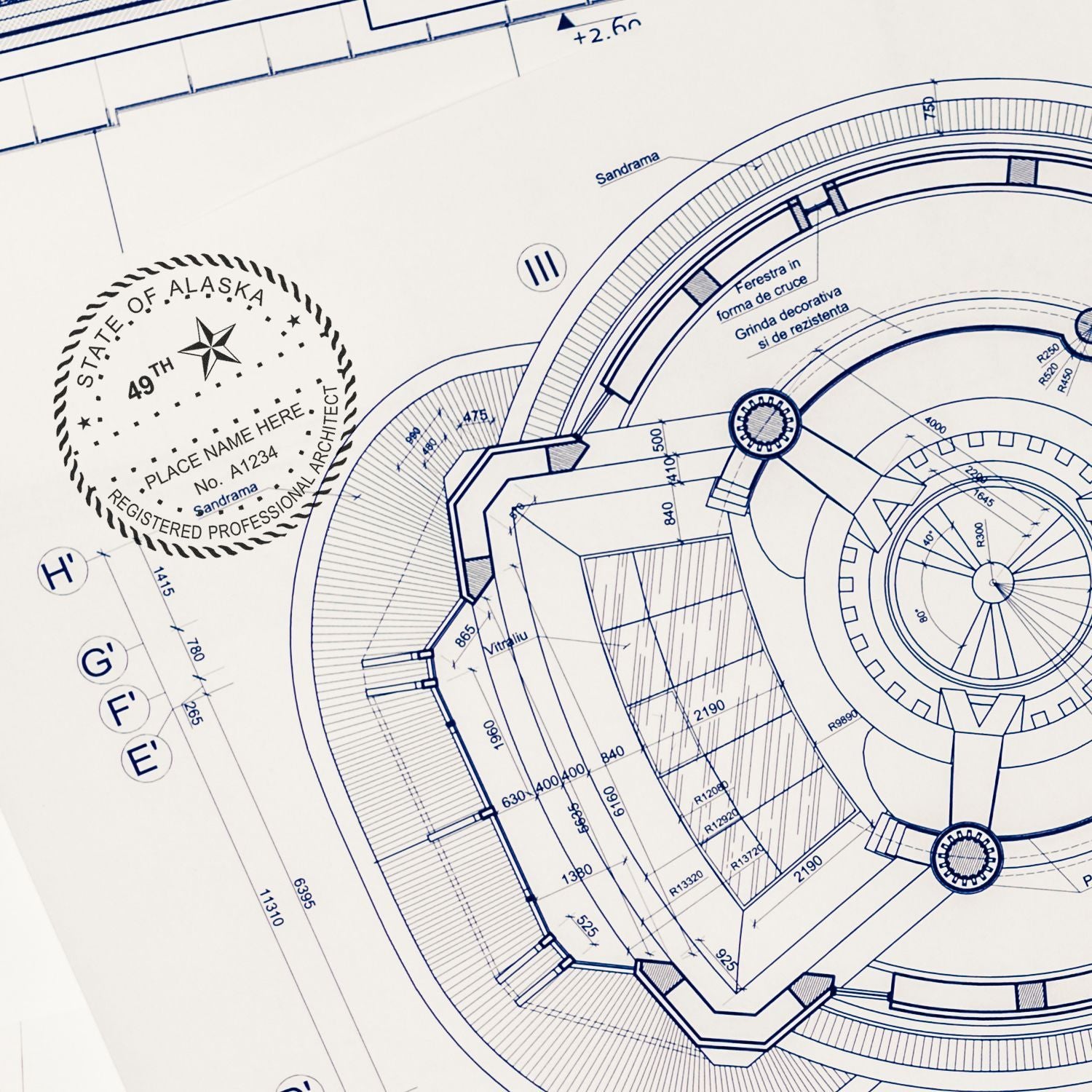 Alaska Architect Seal Stamp on detailed architectural blueprint, showcasing intricate design and professional certification.