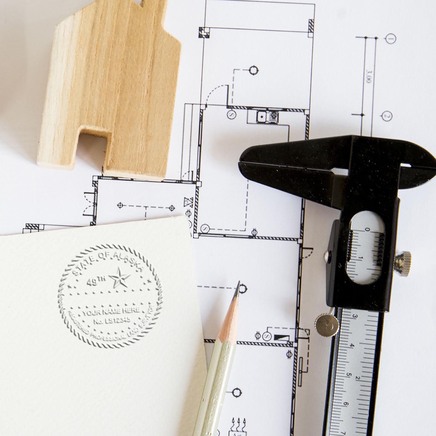 Another Example of a stamped impression of the Handheld Alaska Land Surveyor Seal on a piece of office paper.