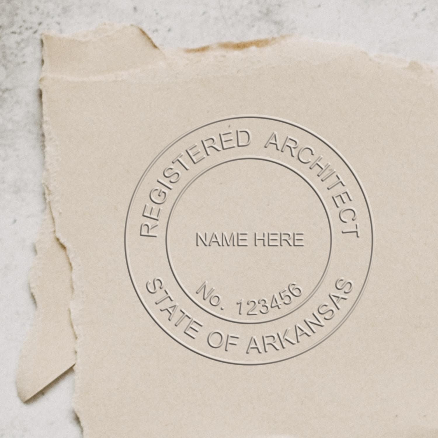A stamped impression of the Handheld Arkansas Architect Seal Embosser in this stylish lifestyle photo, setting the tone for a unique and personalized product.