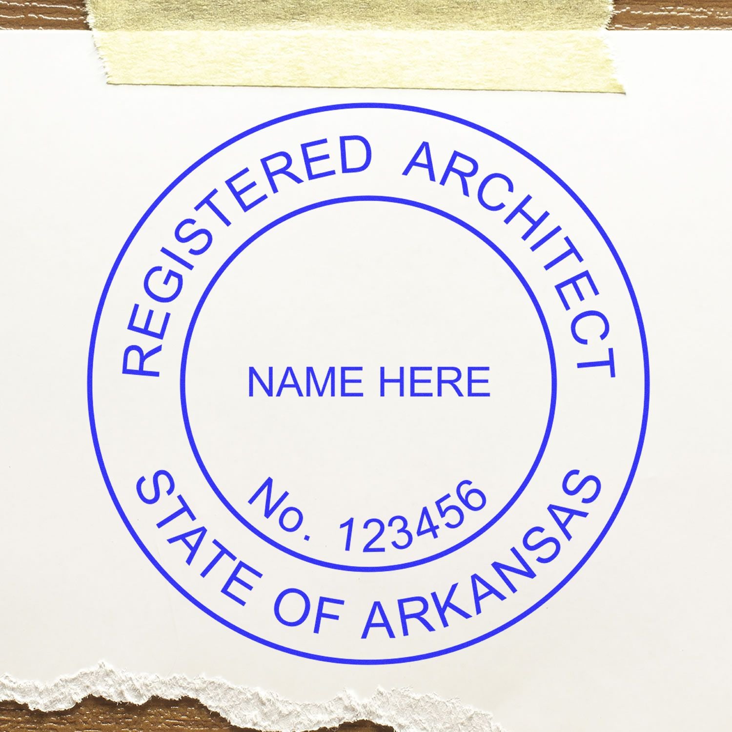 Arkansas Architect Seal Stamp with Registered Architect, State of Arkansas text, space for name and number, on white paper with tape.