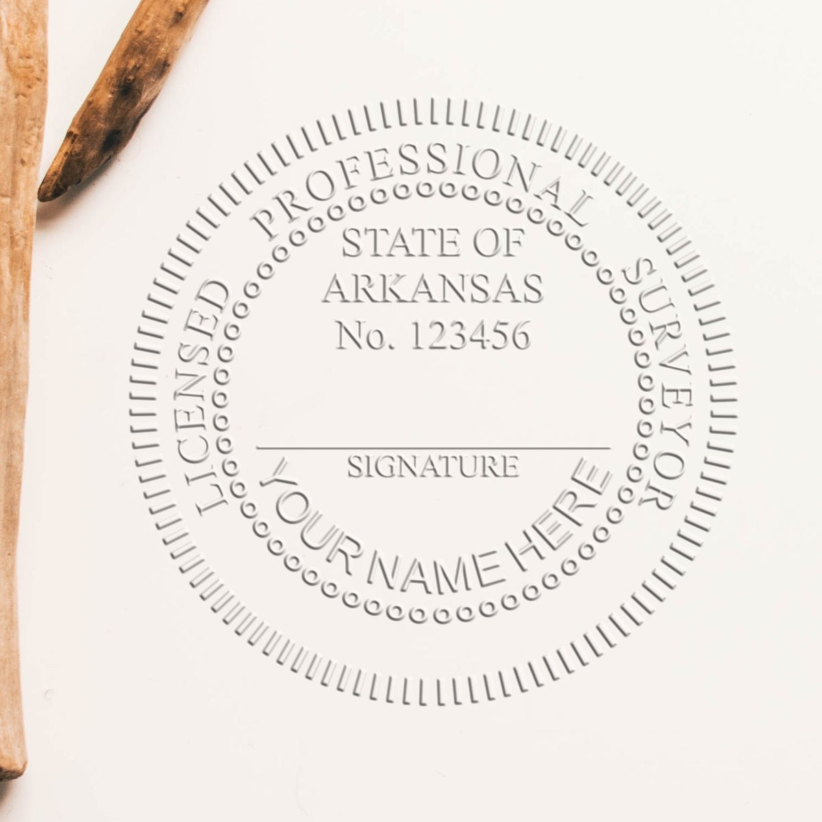 Another Example of a stamped impression of the Heavy Duty Cast Iron Arkansas Land Surveyor Seal Embosser on a piece of office paper.