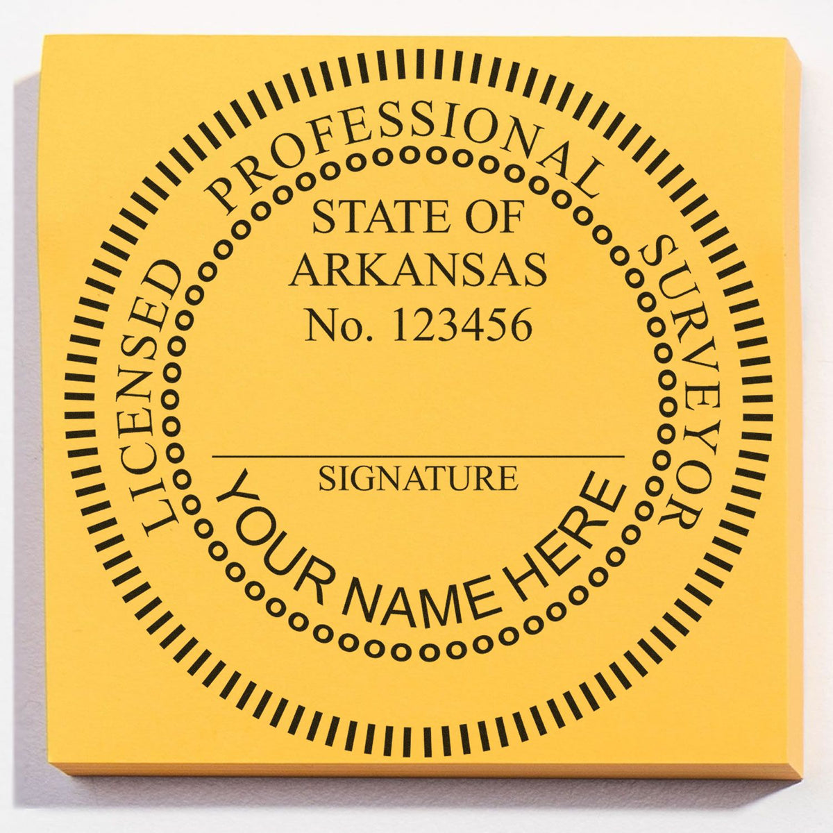 A lifestyle photo showing a stamped image of the Slim Pre-Inked Arkansas Land Surveyor Seal Stamp on a piece of paper