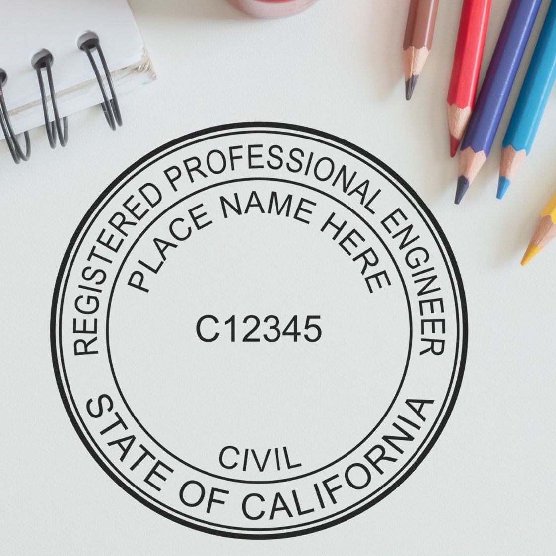 A lifestyle photo showing a stamped image of the Slim Pre-Inked California Professional Engineer Seal Stamp on a piece of paper