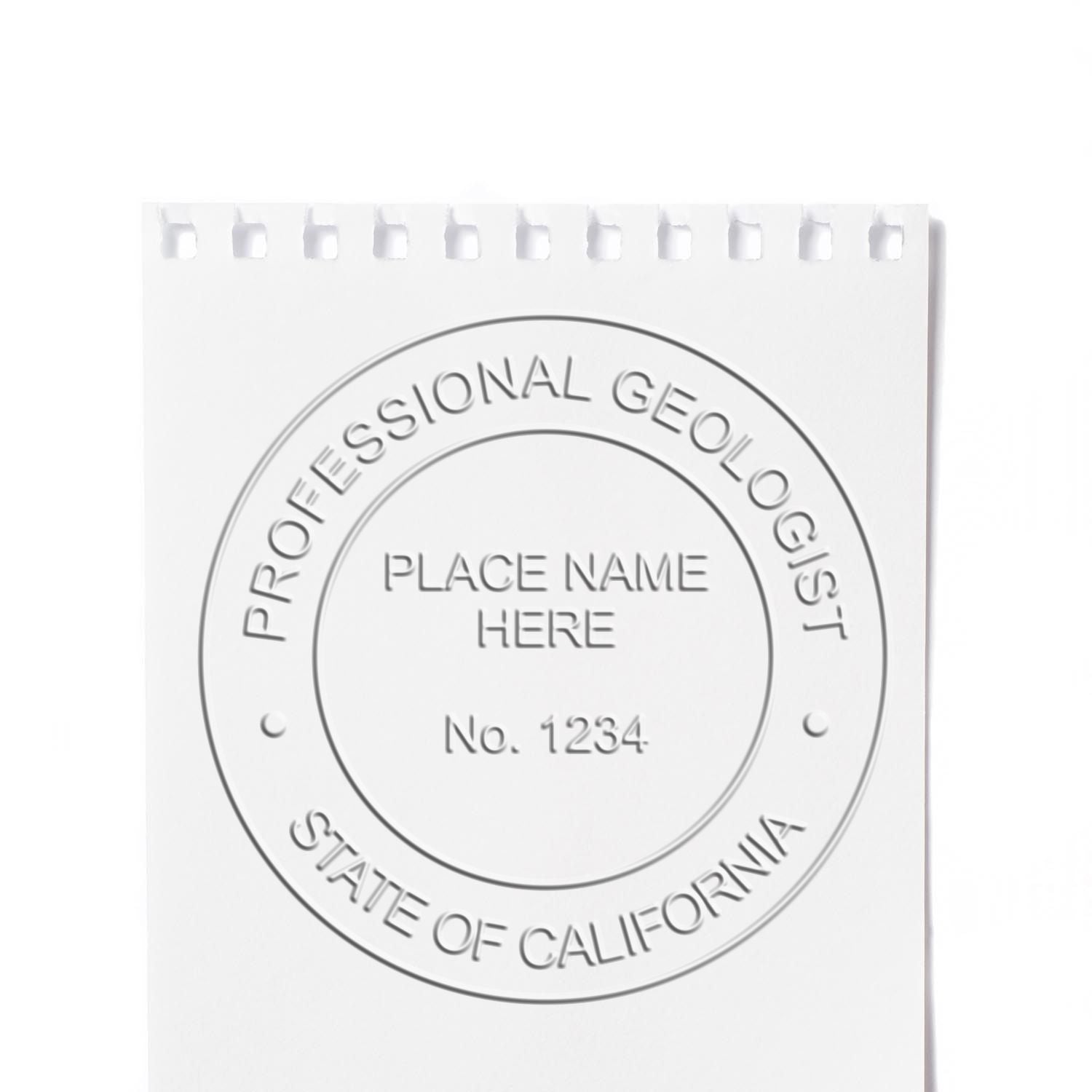 A lifestyle photo showing a stamped image of the Handheld California Professional Geologist Embosser on a piece of paper