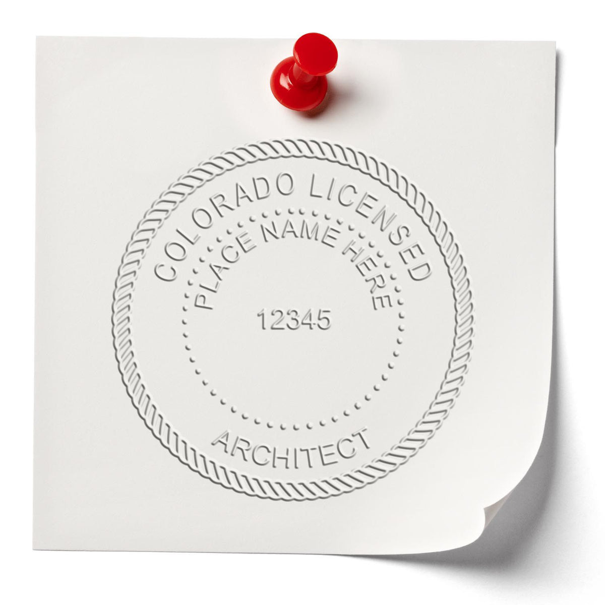 A lifestyle photo showing a stamped image of the Colorado Desk Architect Embossing Seal on a piece of paper