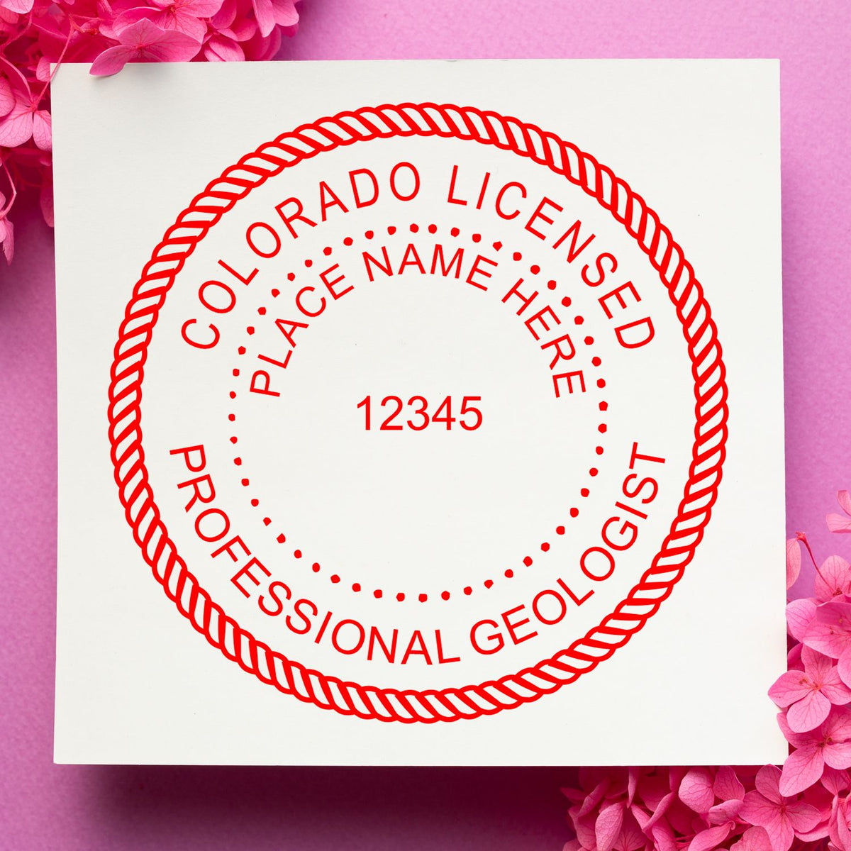 A lifestyle photo showing a stamped image of the Colorado Professional Geologist Seal Stamp on a piece of paper