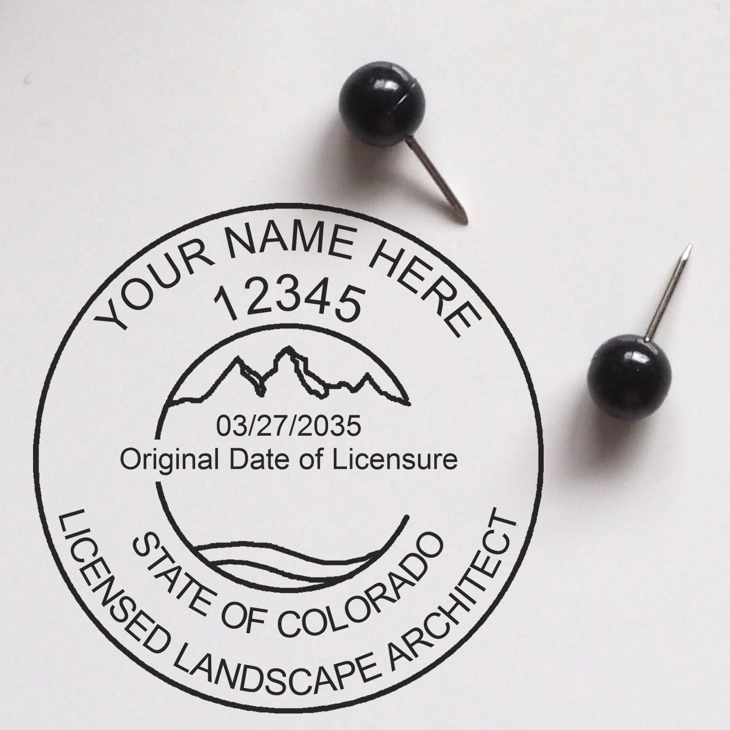 A lifestyle photo showing a stamped image of the Colorado Landscape Architectural Seal Stamp on a piece of paper