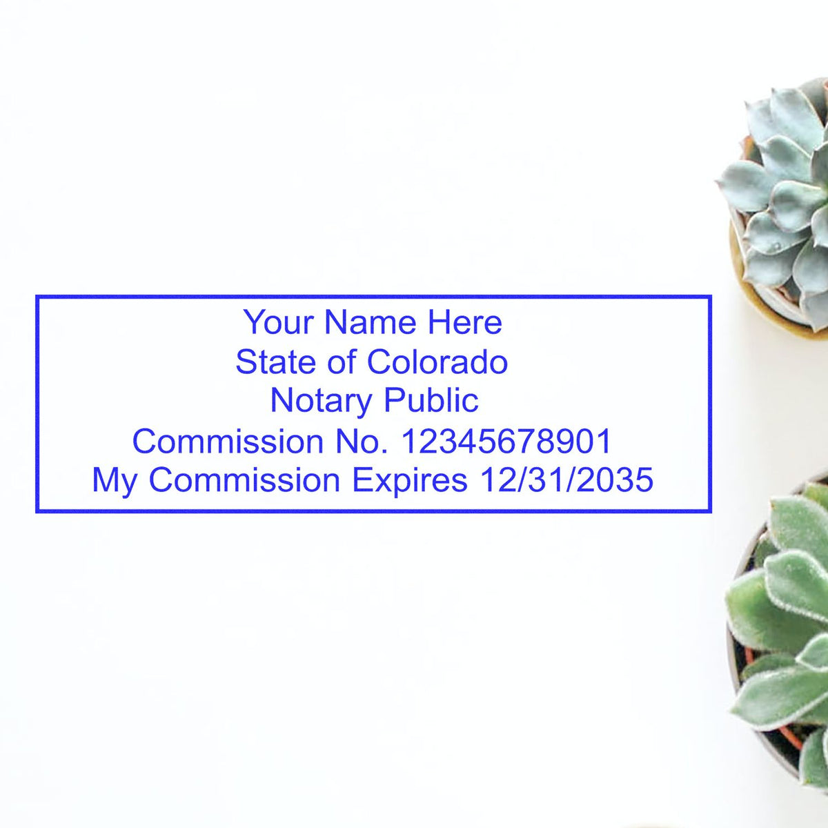 A lifestyle photo showing a stamped image of the Wooden Handle Colorado Rectangular Notary Public Stamp on a piece of paper