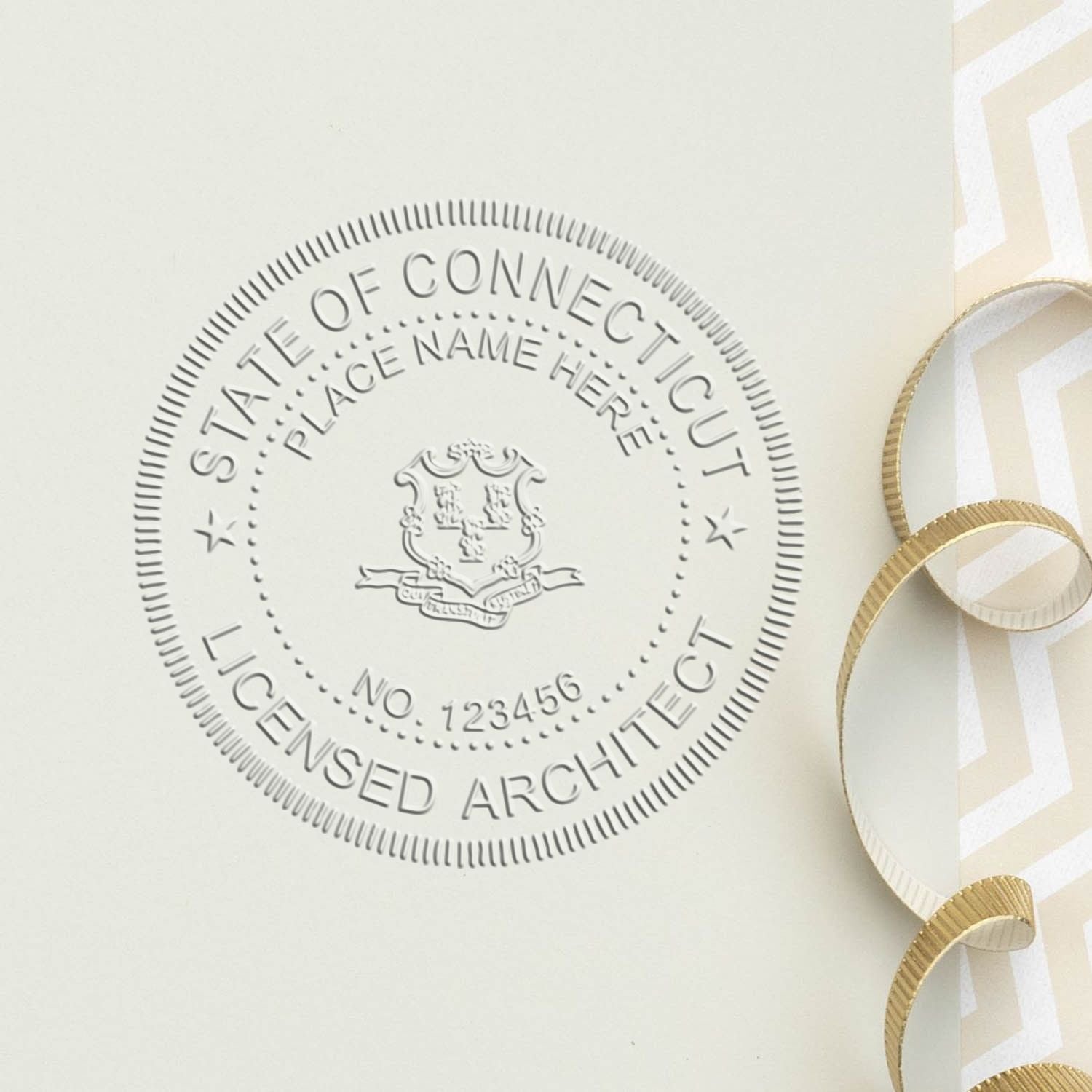 A lifestyle photo showing a stamped image of the Handheld Connecticut Architect Seal Embosser on a piece of paper