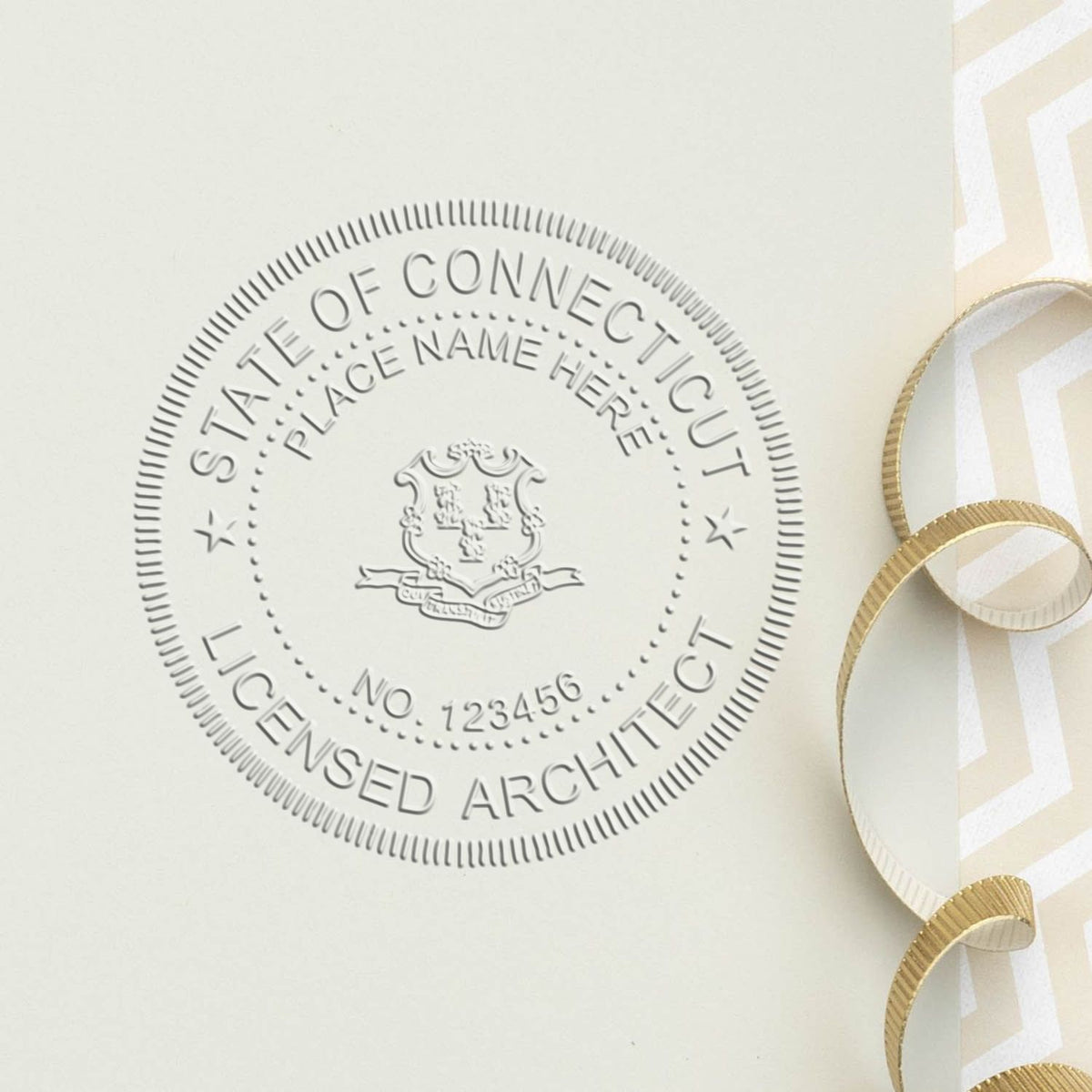 A lifestyle photo showing a stamped image of the Handheld Connecticut Architect Seal Embosser on a piece of paper