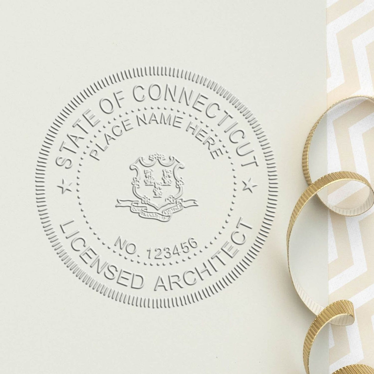 A lifestyle photo showing a stamped image of the Connecticut Desk Architect Embossing Seal on a piece of paper