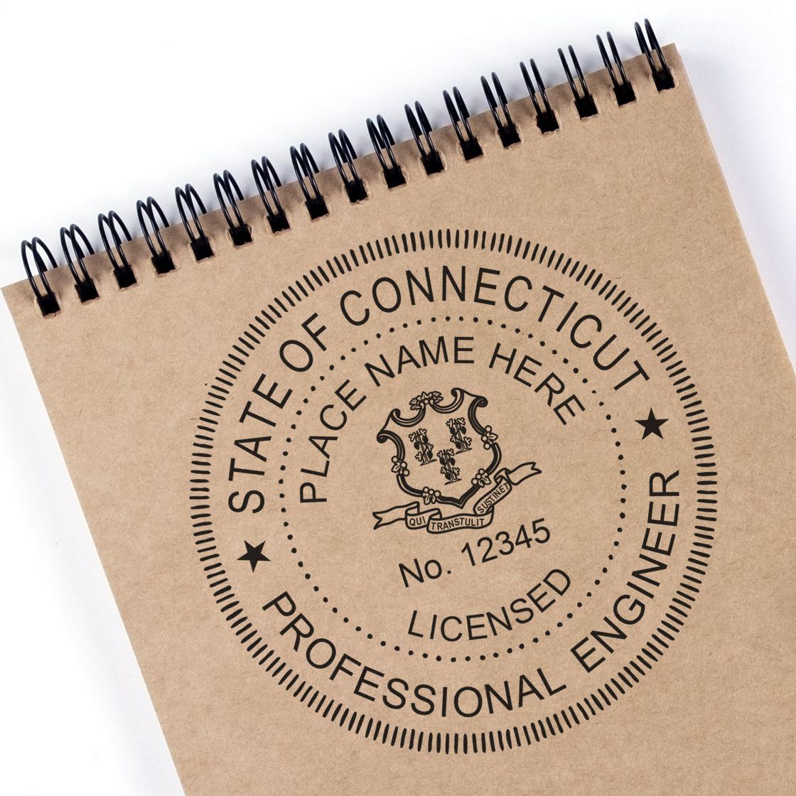 A lifestyle photo showing a stamped image of the Slim Pre-Inked Connecticut Professional Engineer Seal Stamp on a piece of paper