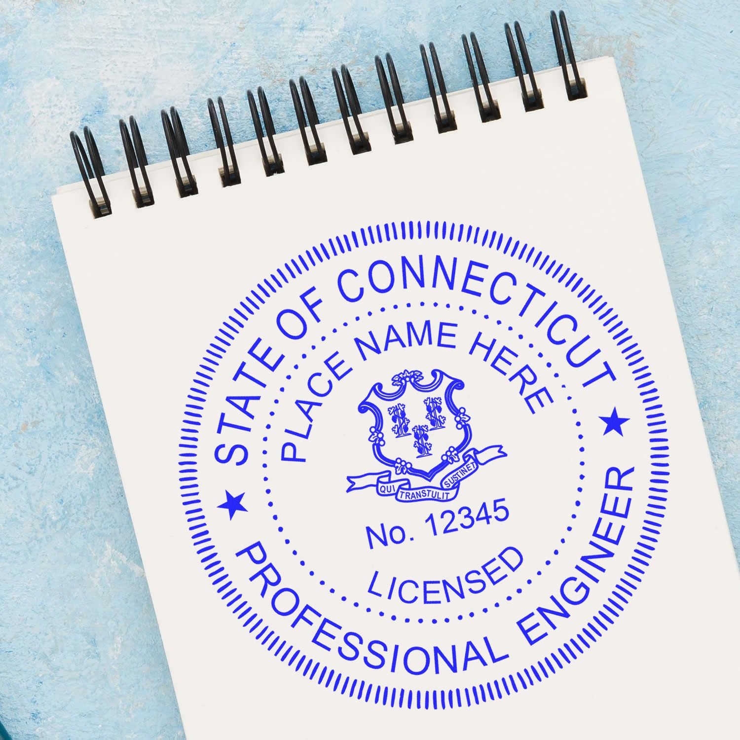 A lifestyle photo showing a stamped image of the Premium MaxLight Pre-Inked Connecticut Engineering Stamp on a piece of paper