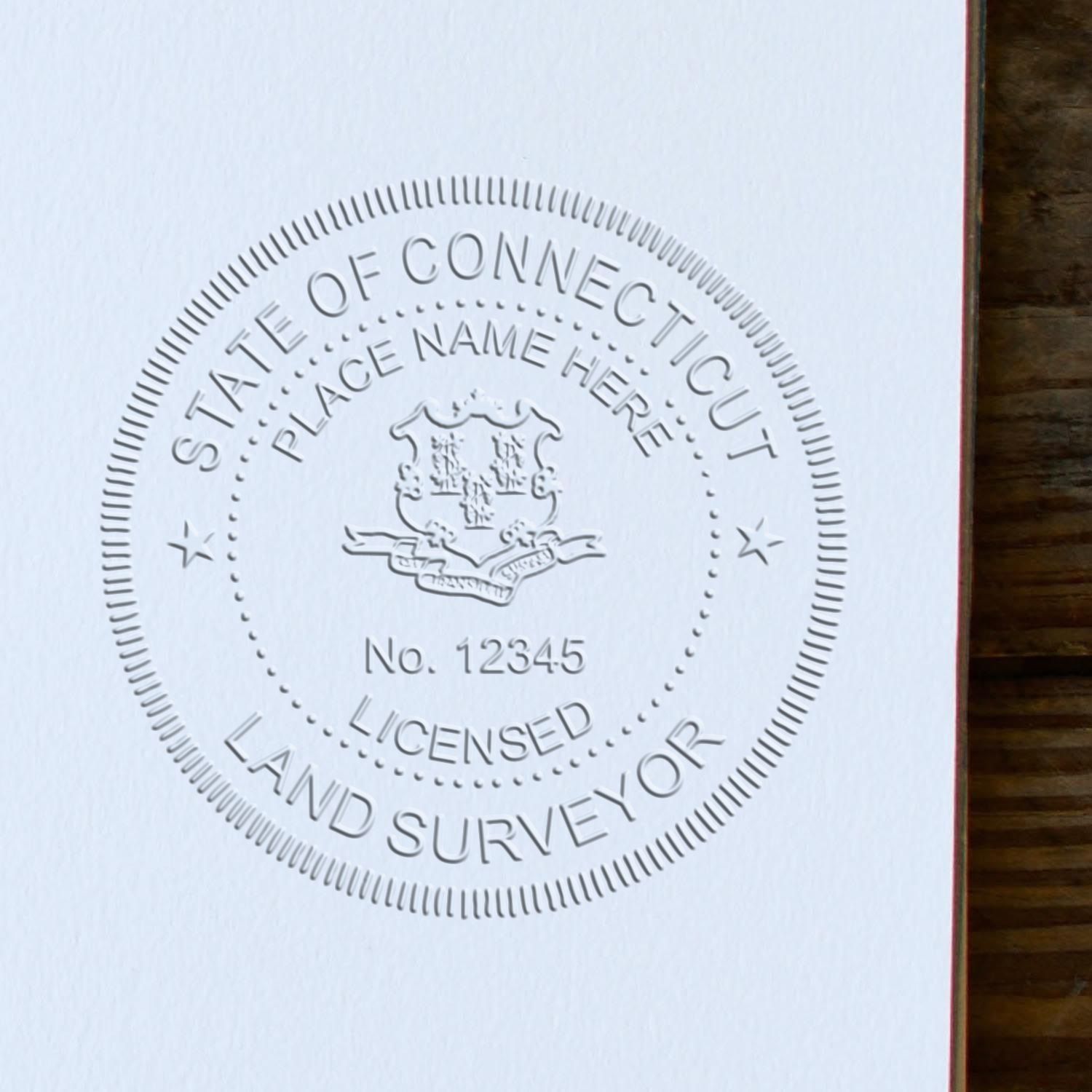 The main image for the Connecticut Desk Surveyor Seal Embosser depicting a sample of the imprint and electronic files