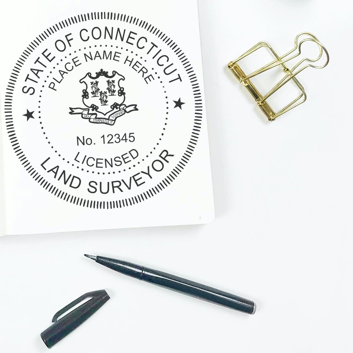 Digital Connecticut Land Surveyor Stamp, Electronic Seal for Connecticut Land Surveyor, displayed on paper with pen and binder clip.