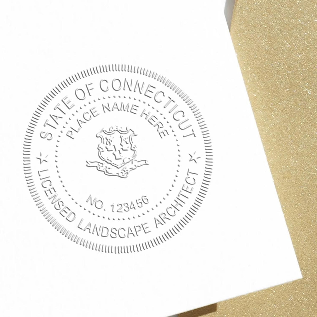 An in use photo of the Hybrid Connecticut Landscape Architect Seal showing a sample imprint on a cardstock
