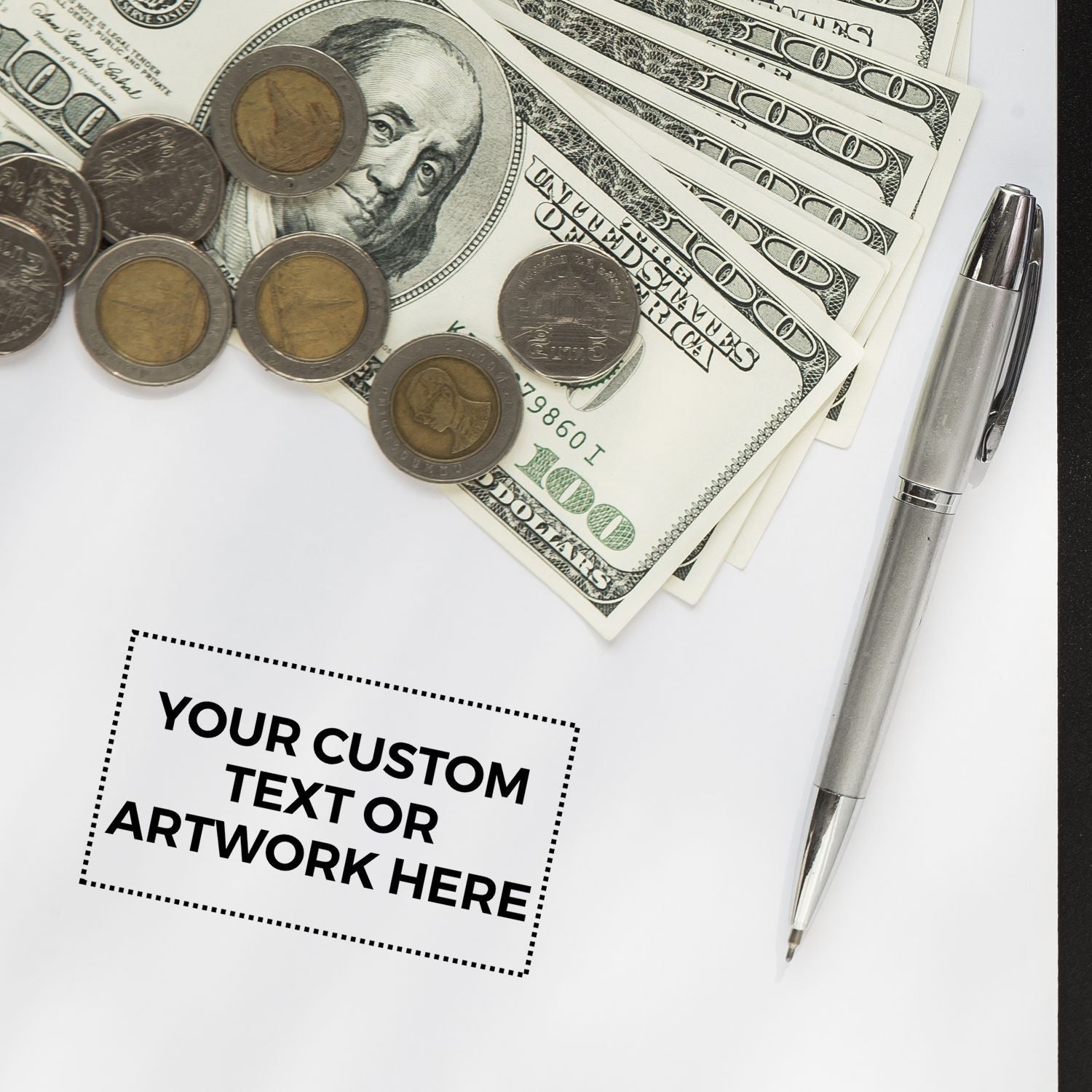 Custom Self Inking Stamp Trodat 5203 Size 1-5/8 x 2 on a desk with money, coins, and a pen, showcasing Your Custom Text or Artwork Here .