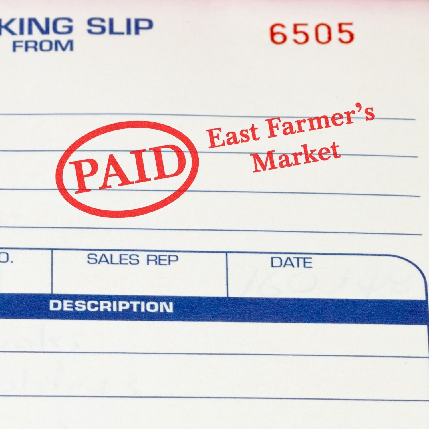 A Custom Self Inking Stamp Trodat 5204 Size 1 x 2-1/4 is used to stamp PAID on a document from East Farmer's Market.